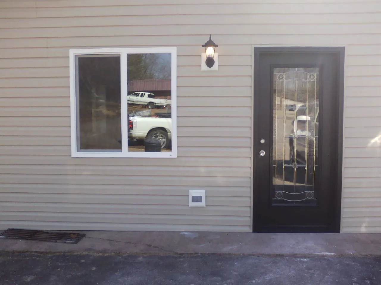 New siding, window and entry door on the side of an addition in Paint Lick
